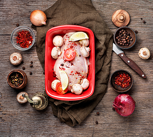 Raw chicken meat with mushrooms in a baking dish.Ingredients for cooking.Chicken breast