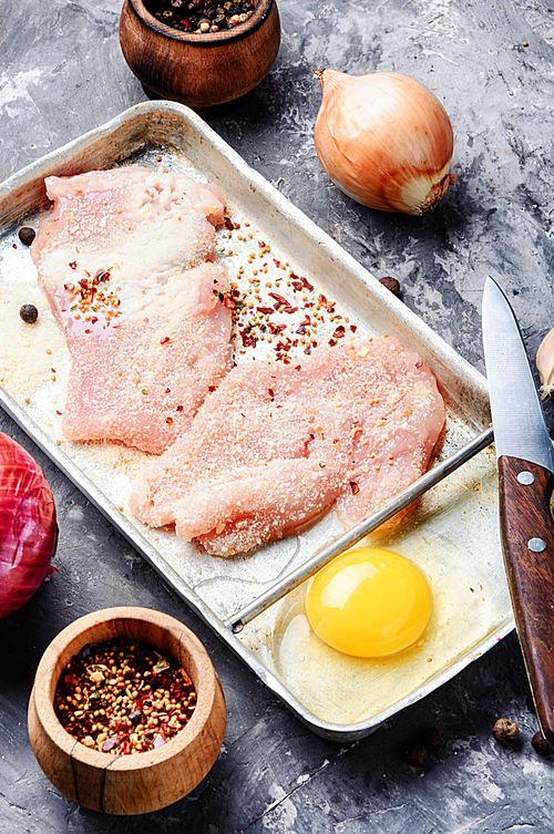 Raw chicken steaks on a kitchen board.Fresh and raw meat.