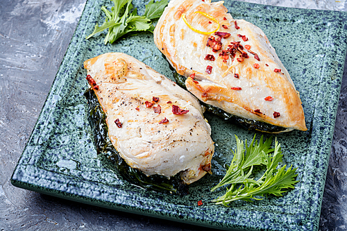 Roasted chicken breasts stuffed with green.Grilled or smoked chicken breast