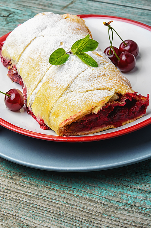 Traditional puff pastry strudel with berries of cherry