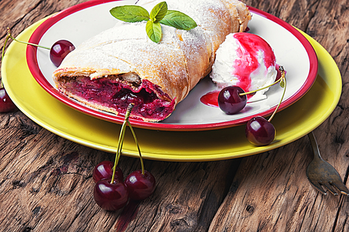 Traditional puff pastry strudel with berries of cherry