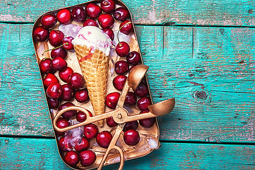 Summer vanilla ice cream in waffle cones and cherry berries