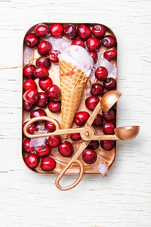 ice cream in waffle cones and cherry on white background