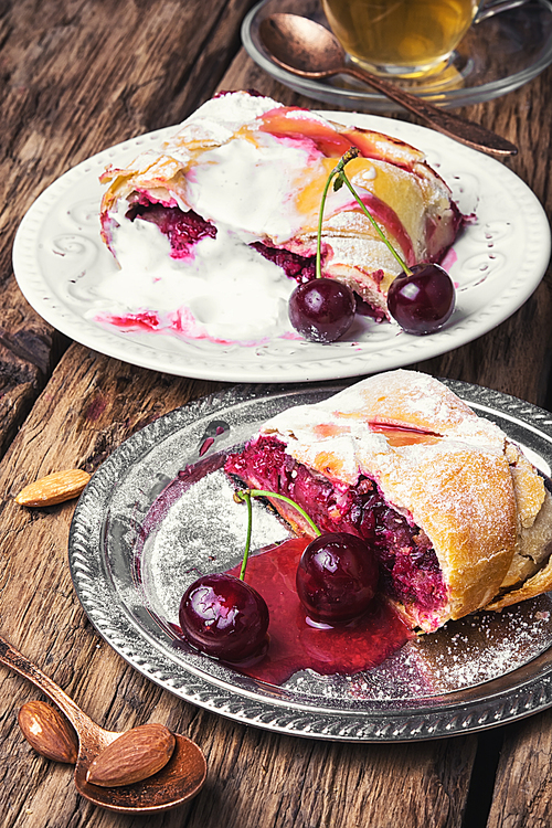 Traditional puff pastry strudel with berries of cherry