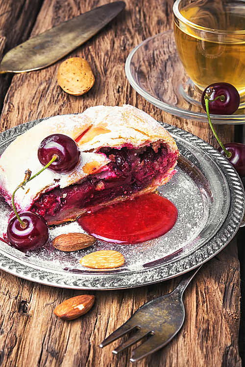 Traditional puff pastry strudel with berries of cherry