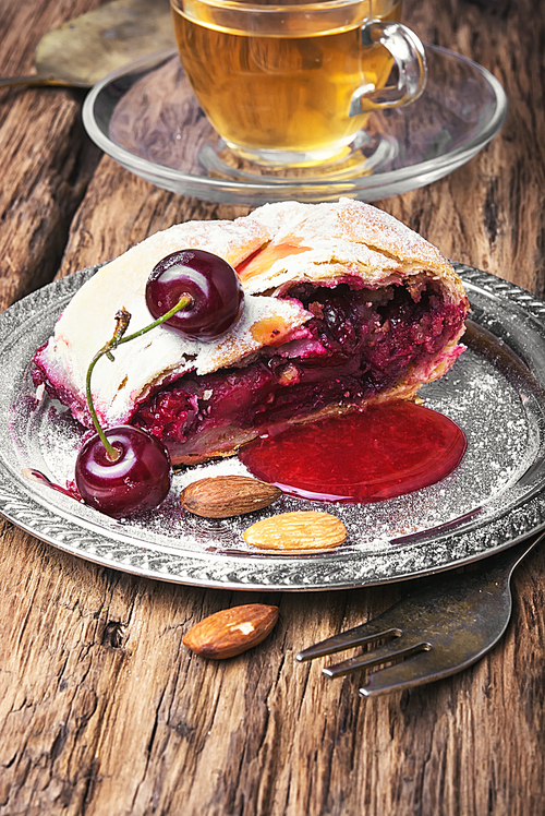 Traditional puff pastry strudel with berries of cherry