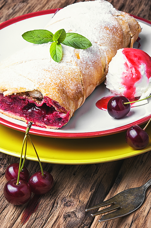 Traditional puff pastry strudel with berries of cherry