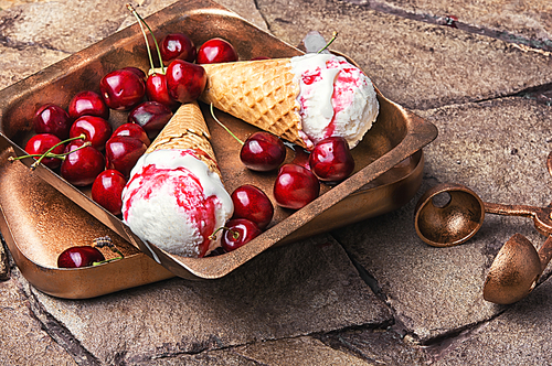 Ice cream in a waffle with cherry jam on a stylish stone background