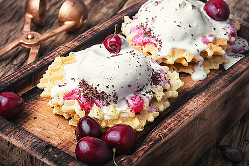 Ice cream on baked wafers with cherries