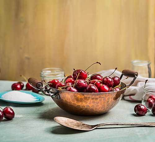 preparing of Sweet cherry preserve,  homemade jam or  jelly on rustic kitchen background