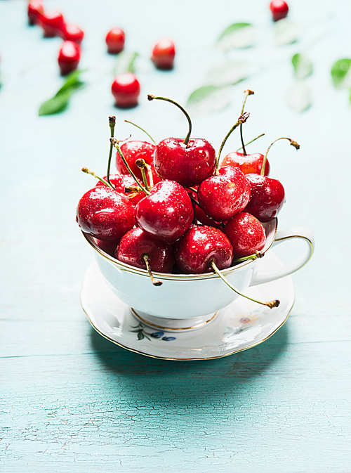 Cup with fresh ripe cherry berries, front view, close up