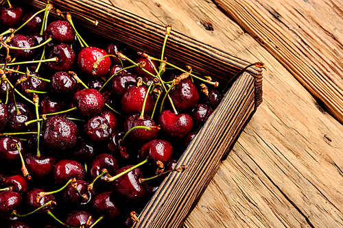 Fresh cherry in box on wooden background.Cherry.Red cherry.