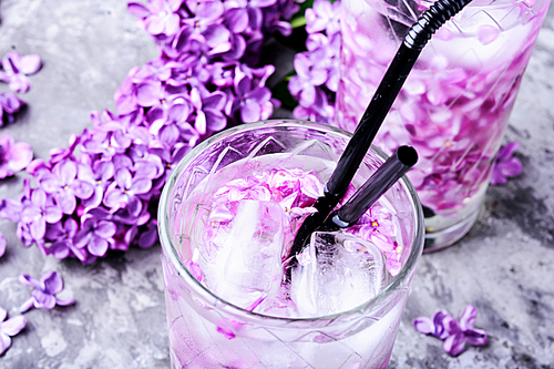 Refreshing summer cocktail with lilac flowers.Detox drink