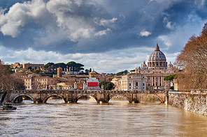 St. Peter's cathedral and Tiber river with high water in February. Saint Peter Basilica in Vatican city with Saint Angelo Bridge in Rome, Italy