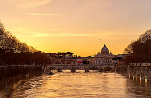 St. Peter's cathedral and Tiber river with high water at  sunset. Saint Peter Basilica in Vatican city with Saint Angelo Bridge in Rome, Italy