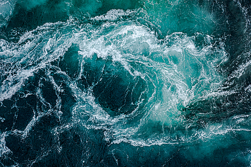 Waves of water of the river and the sea meet each other during high tide and low tide. Whirlpools of the maelstrom of Saltstraumen, Nordland, Norway