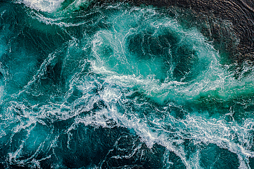 Waves of water of the river and the sea meet each other during high tide and low tide. Whirlpools of the maelstrom of Saltstraumen, Nordland, Norway