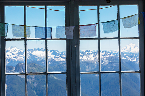 Wooden window with summer mountains. Wanderlust travel concept.
