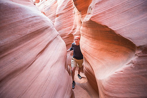 Slot canyon in Grand Staircase Escalante National park, Utah, USA. Unusual colorful sandstone formations in deserts of Utah are popular destination for hikers. Living coral toned.