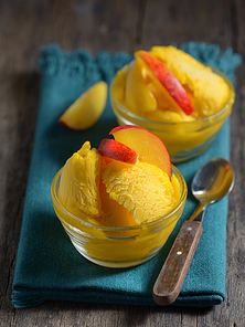Homemade mango ice sorbet with peach slices