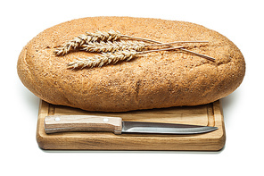 bread on carvig board with kitchen knife and ears isolated white