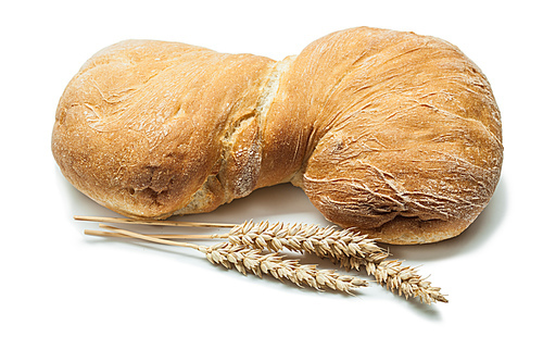 loaf of sweet bread and wheat ears isolated on white