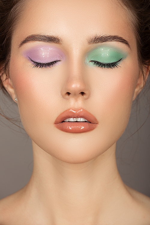 Fashion portrait of young woman. Colorful eye shadows. Perfect skin.
