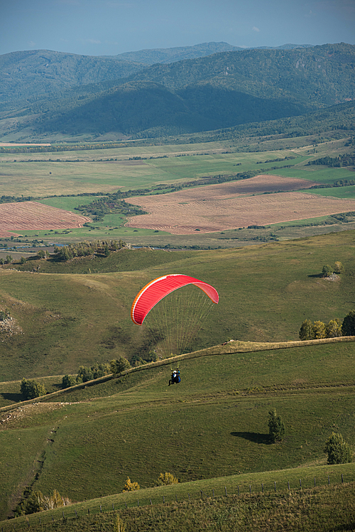 Paragliding in the mountains. Paragliders in fight in the mountains, extreme sport activity.