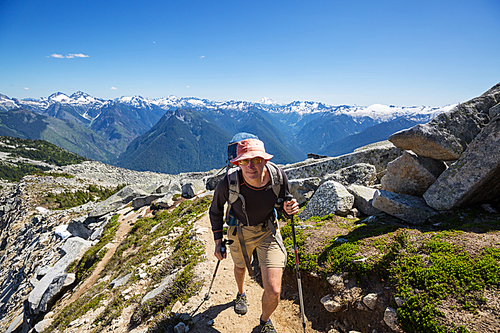 Backpacker in a hike in the summer mountains