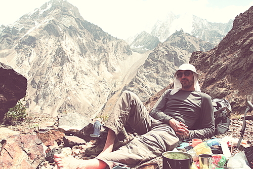 Backpacker in a hike in the summer mountains