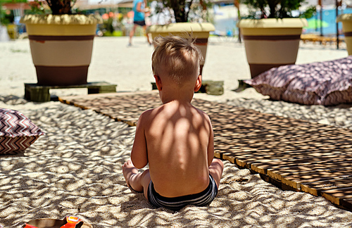 Two year old toddler boy on beach