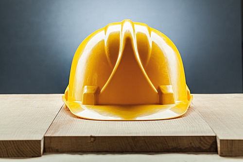 yellow construction helmet on wood board