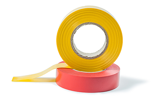 red and yellow insulation tape rolls isolated on white