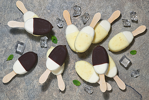 Ice cream in chocolate and white chocolate glaze on a stick