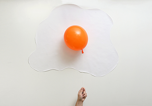 Abstract Orange Balloon With White Paper In Shape Of An Fried Egg