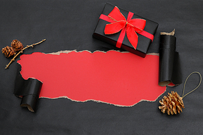 Top View Of Black Torn Paper And A Gift