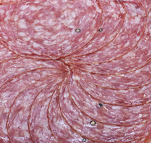 Salami slices isolated on white, close up