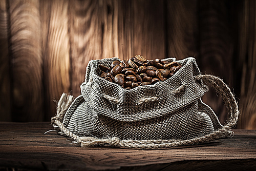 vintage vith coffee beans sack on old wood desk and wooden background1