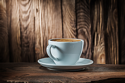 white coffee cup on vintage wood background