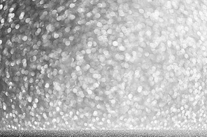 Shiny silver bokeh glitter lights abstract background, Christmas New Year party celebration concept