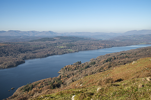 Beautiful Autumn Fall landscape image of view from Gummers How down onto Derwent Wter in Lake District