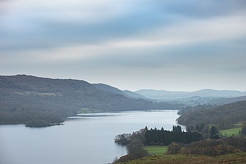 Landscape image of Consiton Water in Lake District viewed from near Kelly Hall Tarn during Autumn Fall with mist hanging over the lake