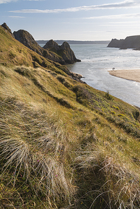 beautiful summer evening  beach landscape image at three cliffs bay in south wales