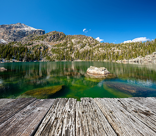 Lake Haiyaha with rocks and mountains in snow around at autumn. Rocky Mountain National Park in Colorado, USA.