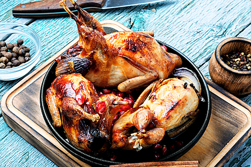 Quail roasted with pomegranate sauce in frying pan