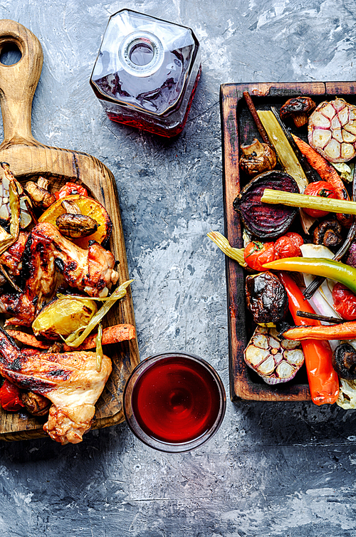 Grilled chicken wings with grilled vegetables.BBQ chicken wings.Summer barbecue