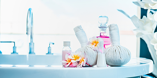 Frangipani flowers  with herbal compress stamps , pink lotion bottle on  luxury bath. Spa or wellness background