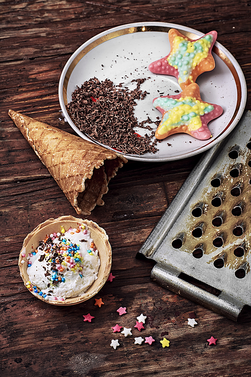 ice cream decorated with sweet powder in the wafer on wooden background