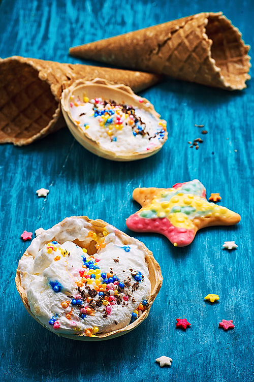 ice cream decorated with sweet powder in the wafer on wooden background