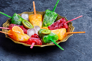 summer dish of ice cream with flavors of kiwi,pomegranate and oranges.View top